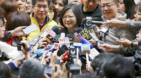 Taiwan's Democratic Progressive Party (DPP) Chairperson and presidential candidate Tsai Ing-wen smiles as she addresses reporters after casting her ballot at a polling station during general elections in New Taipei City