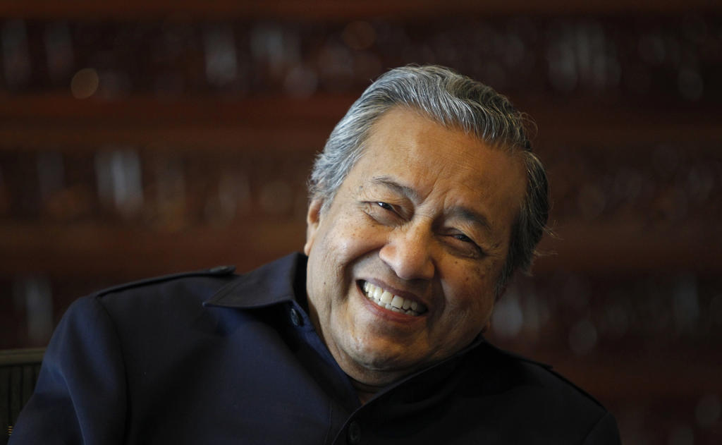 Former Malaysia's Prime Minister Mahathir Mohamad smiles as he speaks to Reuters during an interview at his office in Putrajaya outside Kuala Lumpur May 4, 2011. The man who made Malaysia part of the "East Asia Miracle" with a massive inflow of foreign direct investment doesn't think much of it today. The former emerging markets star, now a muddle, needs a new policy direction, says Dr. Mahathir Mohamad. To match Special Report - MALAYSIA-DILEMMA/  REUTERS/Bazuki Muhammad (MALAYSIA - Tags: POLITICS HEADSHOT) - GM1E7761DPT01
