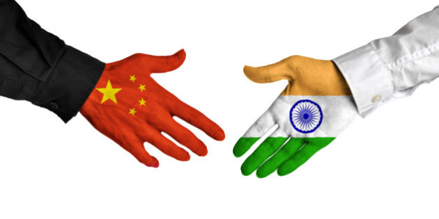 China and India leaders shaking hands on a deal agreement