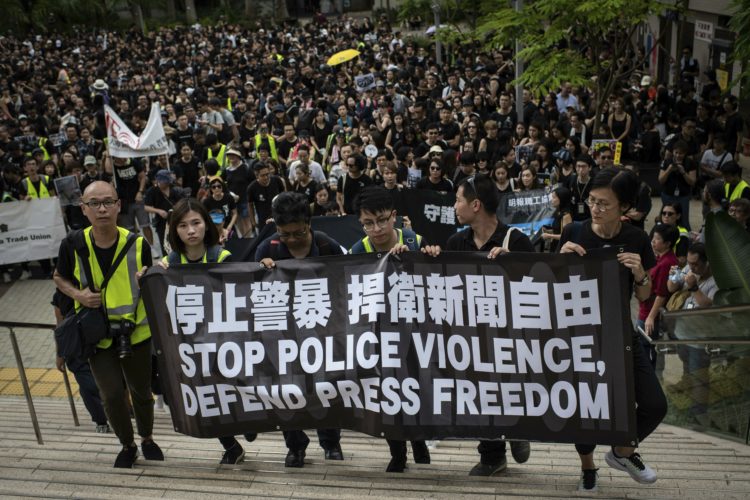 Protesters hold a banner during a march claiming for press freedom. Media groups and journalist trade unions held a "Stop Police Violence, Defend Press Freedom" silent march to express demands that police facilitates the work of news media and respect press freedom. The protest were called after media professionals suffered aggressions and were insulted by police officers while covering the protests against the extradition law to China. (Photo by Ivan Abreu / SOPA Images/Sipa USA)(Sipa via AP Images)
