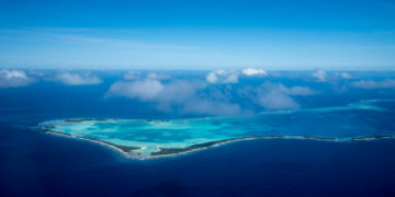 Aerial shot of Tuvalu.   Tuvalu is located in the Pacific Ocean, in the middle of Hawaii and Australia. It was formerly known as Ellice Islands.