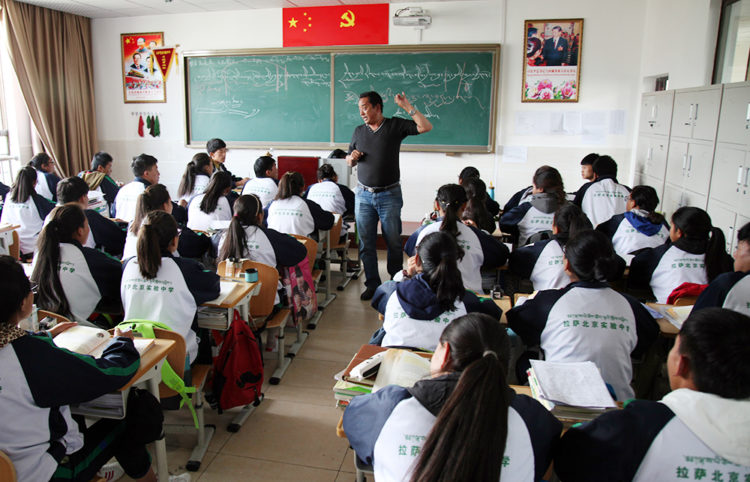 In this Friday, Sept. 18, 2015 photo, students listen to a Tibetan-language lesson at the Lhasa-Beijing Experimental Middle School in Lhasa, capital of the Tibet Autonomous Region of China. Top-down development has poured more than $100 billion dollars into the region since 1952, but critics say that Beijing’s obsession with social stability also has led to widespread human right abuses. (AP Photo/Aritz Parra)