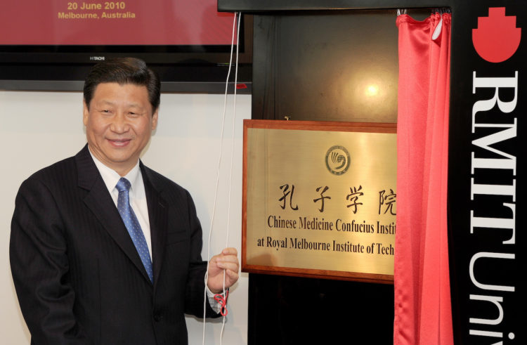 China's Vice President Xi Jinping unveils the plaque at the opening of Australia's first Chinese Medicine Confucius Institute at the RMIT University in Melbourne on June 20, 2010.  The Confucius Institute will promote the study of Chinese culture and language with a focus on Chinese Medicine - one of the world's oldest and longest standing healthcare systems, tracing back more than 2,500 years.  Xi is on a five-day visit to Australia.  AFP PHOTO/William WEST (Photo credit should read WILLIAM WEST/AFP/Getty Images)