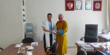 Honorary Representative Telo Tulku Rinpoche presenting a book “Beyond Religion” to the Minister of Culture, Mr Erdne Barinov.