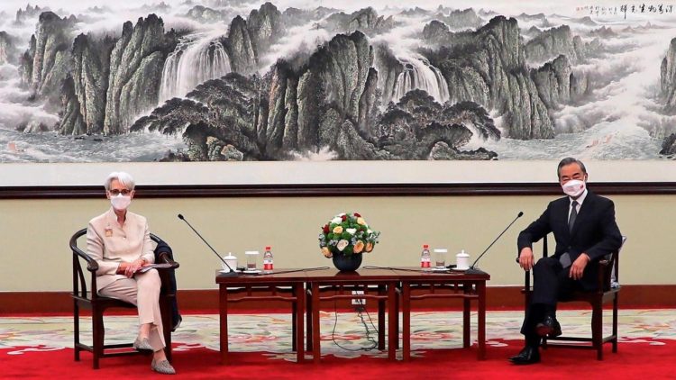 US Deputy Secretary of State Wendy Sherman and Chinese Foreign Minister Wang Yi sit together in Tianjin, China on Monday.(AP Photo)