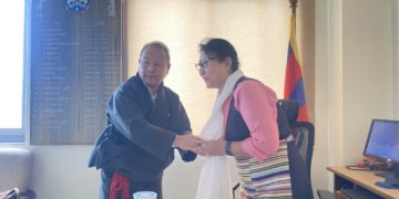 Outgoing Secretary Tsegyal Dranyi greets the new Secretary of the Department of Religion and Culture, Chime Tseyang. Photo Source (CTA)