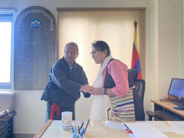 Outgoing Secretary Tsegyal Dranyi greets the new Secretary of the Department of Religion and Culture, Chime Tseyang. Photo Source (CTA)