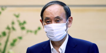 Japan's Prime Minister Yoshihide Suga attends a meeting with president of the International Paralympic Committee (IPC) Andrew Parsons in Tokyo, Japan September 3, 2021, following his announcement that he will not seek re-election for Liberal Democratic Party (LDP) leadership this month. Behrouz Mehri/Pool via REUTERS