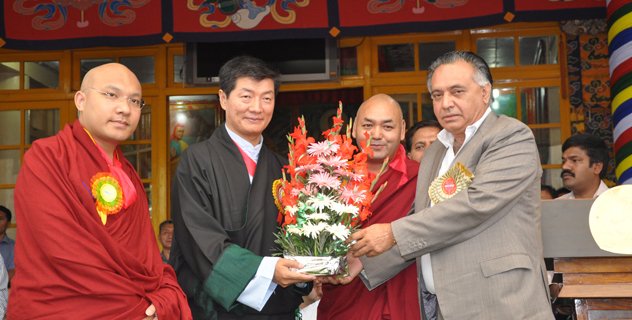 Mr G S Bali, Transport, Food, Civil Supplies & Consumer Affairs and Technical Education Minister in Himachal Pradesh government presents a bouquet from the Chief Minister to Sikyong Dr. Lobsang Sangay as a tribute to His Holiness the Dalai Lama on his 79th birthday celebrations in Dharamsala, India, 6 July 2014/DIIR Photo/Tenzin Phende