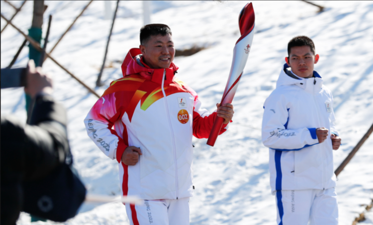 Qi Fabao, the Chinese PLA Commander carries the torch during the Beijing 2022 Olympic Torch Relay in Beijing on Feb.