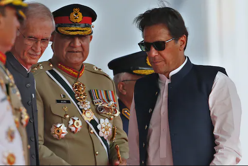 Pakistan PM Imran Khan, army chief Gen Qamar Javed Bajwa (centre) and defence minister Pervez Khattaq at a military parade. Image: AP/File