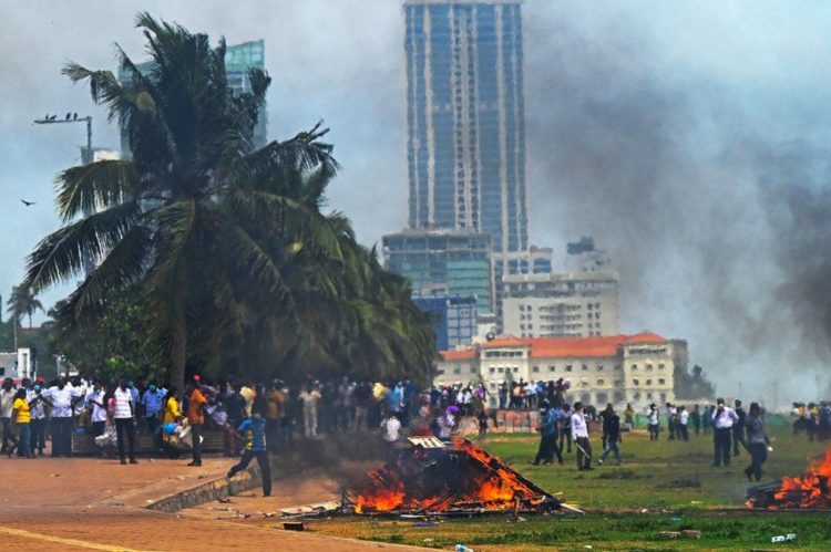 Demonstrators and government supporters clash outside in Colombo on Monday. Photograph: Ishara S Kodikara/AFP/Getty