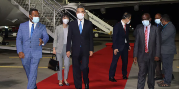 The Solomon Islands' foreign minister, Jeremiah Manele, left, escorts his Chinese counterpart, Wang Yi, center, upon Wang's arrival in Honiara on May 25. (AFP/Getty Images)