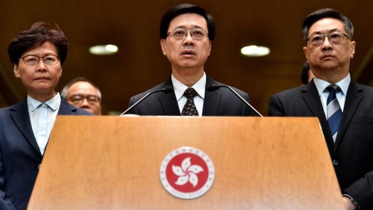 Mr Lee (centre) became one of the faces of the local government in 2019 when police clashed with protesters in the streets. Photo: GETTY IMAGES