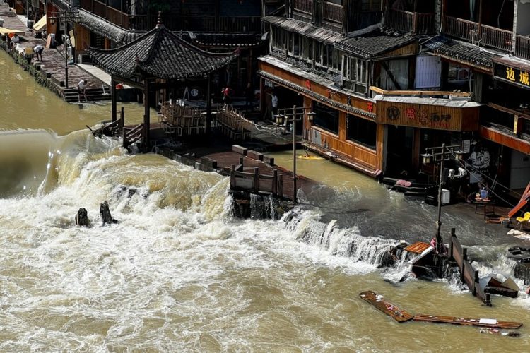 CORRECTS TOWN - Flood waters sweep through the ancient town of Feng Huang in central China’s Hunan province, Saturday, June 4, 2022. State media reported some deaths and missing in flooding in the province. (AP Photo) (Uncredited/AP)