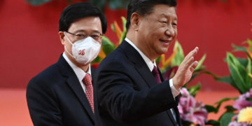 Hong Kong's new Chief Executive John Lee (L) walks with China's President Xi Jinping (R) following Xi's speech after a ceremony to inaugurate the city's new leader and government in Hong Kong on July 1, 2022, on the 25th anniversary of the city's handover from Britain to China. (Photo by Selim CHTAYTI / POOL / AFP) (Photo by SELIM CHTAYTI/POOL/AFP via Getty Images)