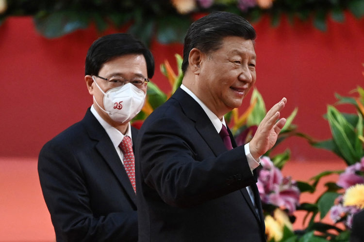 Hong Kong's new Chief Executive John Lee (L) walks with China's President Xi Jinping (R) following Xi's speech after a ceremony to inaugurate the city's new leader and government in Hong Kong on July 1, 2022, on the 25th anniversary of the city's handover from Britain to China. (Photo by Selim CHTAYTI / POOL / AFP) (Photo by SELIM CHTAYTI/POOL/AFP via Getty Images)