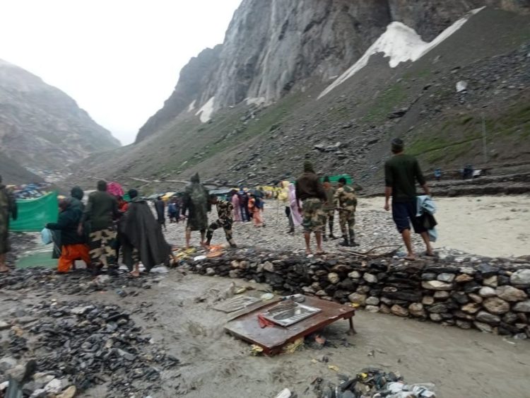 Amarnath Tragedy: 15 dead, Yatra temporarily suspendedRescue officials carry an injured pilgrim. Photo by Ashraf WaniMembers of National Disaster Response Force walk towards cloudburst affected area for rescue work, at Baltal in Ganderbal district of Central Kashmir