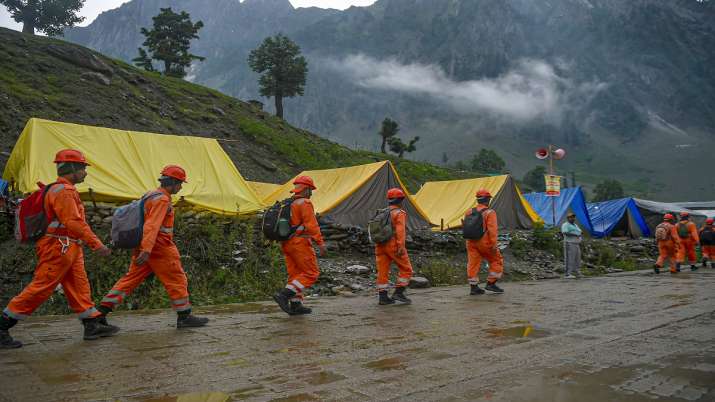 Members of National Disaster Response Force walk towards cloudburst affected area for rescue work, at Baltal in Ganderbal district of Central Kashmir