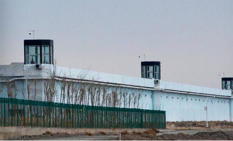 A person stands in a tower on the perimeter of the No. 3 Detention Center in Dabancheng in western China's Xinjiang Uyghur Autonomous Region on April 23, 2021.