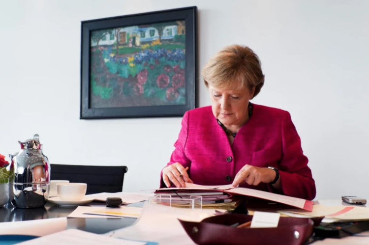 Dr. Angela Merkel, then Federal Chancellor of Germany, works in her office at the Federal Chancellery building in Berlin in 2011.  © UNHCR/Steffen Kugler