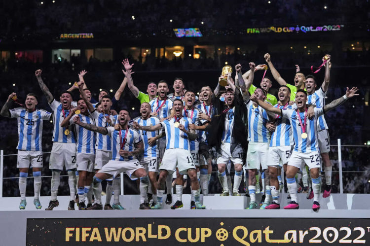 Argentina's Lionel Messi holds up the trophy after winning the World Cup final soccer match between Argentina and France at the Lusail Stadium in Lusail, Qatar, Sunday, Dec.18, 2022. (AP Photo/Manu Fernandez)