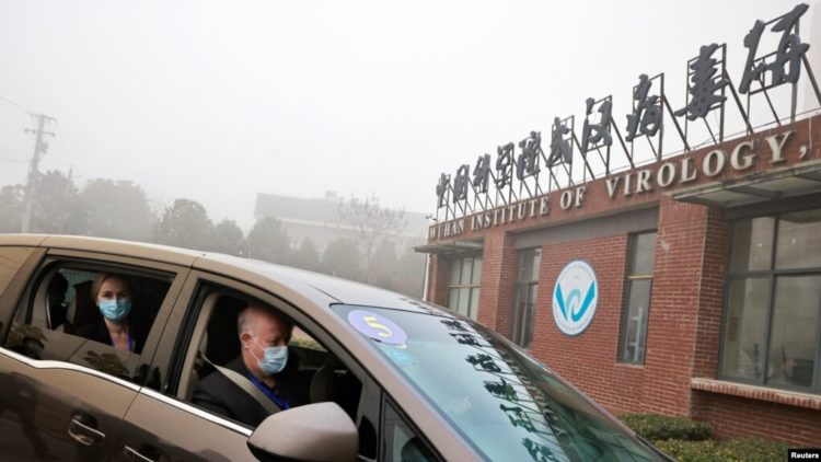 Peter Daszak and Thea Fischer, members of the World Health Organization team tasked with investigating the origins of the coronavirus disease, sit in a car arriving at Wuhan Institute of Virology in Wuhan, China, Feb. 2, 2021.
