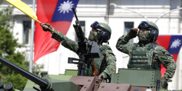 Taiwanese soldiers salute during National Day celebrations in front of the Presidential Building in Taipei.(AP Photo/Chiang Ying-ying)