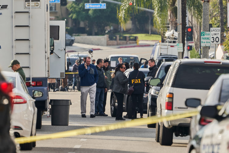MONTEREY PARK, CA - January 22: FBI investigators  stand near the Star Dance Studio (not pictured) where a gunman killed 10 people and injured another 10 in Monterey Park, California on January 22, 2023. The shooting happened in the evening of January 21. (Photo by Philip Cheung for The Washington Post via Getty Images)