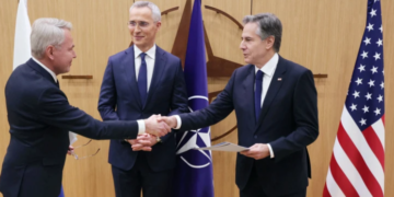 Finnish Foreign Affairs Minister Pekka Haavisto shakes hands with Secretary of State Antony Blinken in Brussels on Tuesday. NATO Secretary-General Jens Stoltenberg is between them. AFP - Getty Images
