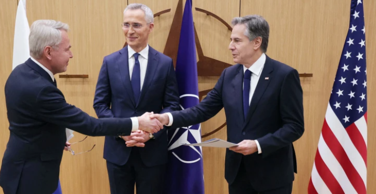 Finnish Foreign Affairs Minister Pekka Haavisto shakes hands with Secretary of State Antony Blinken in Brussels on Tuesday. NATO Secretary-General Jens Stoltenberg is between them. AFP - Getty Images