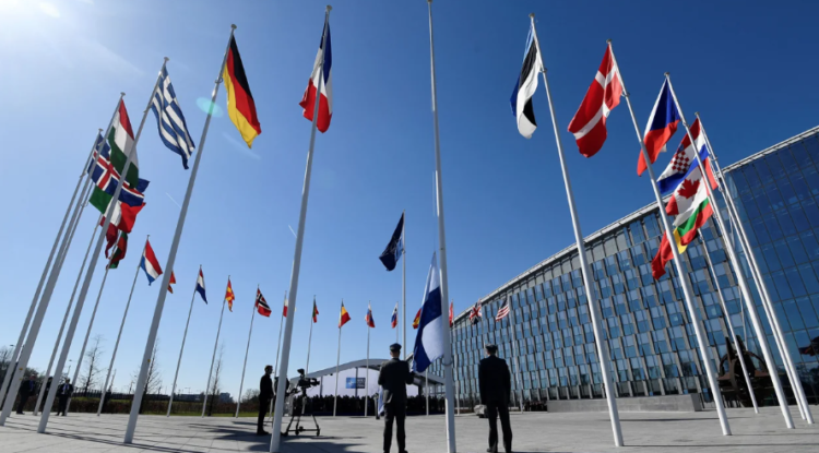 Finnish military personnel raise the Finnish national flag in Brussels after the country formally joined NATO on Tuesday.