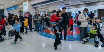 Parents wait for their children to be treated for respiratory disease in Chongqing, China.Credit: Costfoto/NurPhoto via Getty