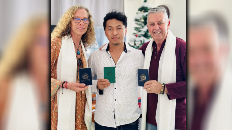 Tom and Elaine Berndt with MP Tenzin Doring flashing the Greenbook and Blue books