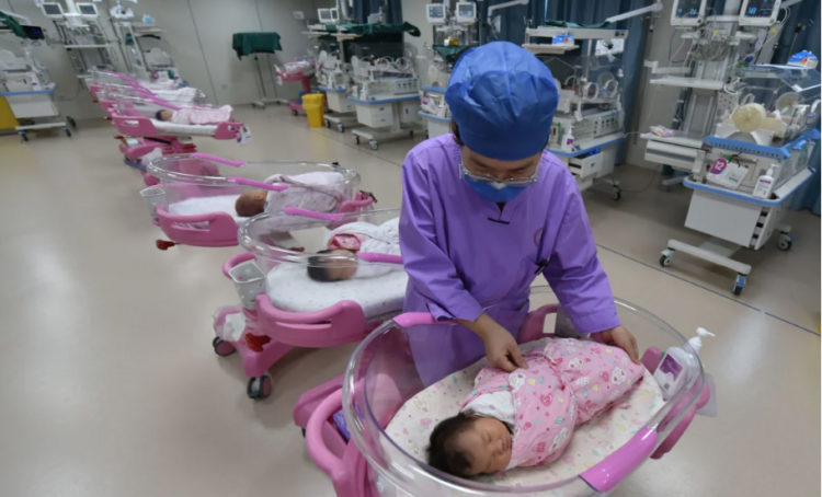 A nurse cares for a newborn at the Women and Children's Hospital in Fuyang City, Anhui province, on August 8, 2022.