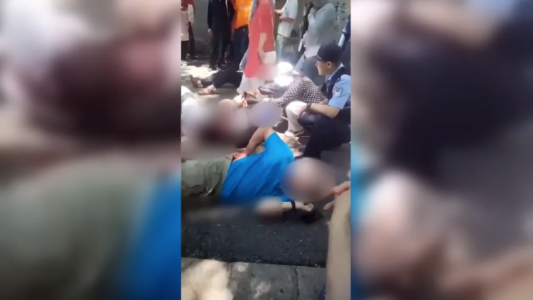 Victims of a stabbing attack are seen lying on the ground in Beishan Park, Jilin, China on Monday, June 10, 2024. social media