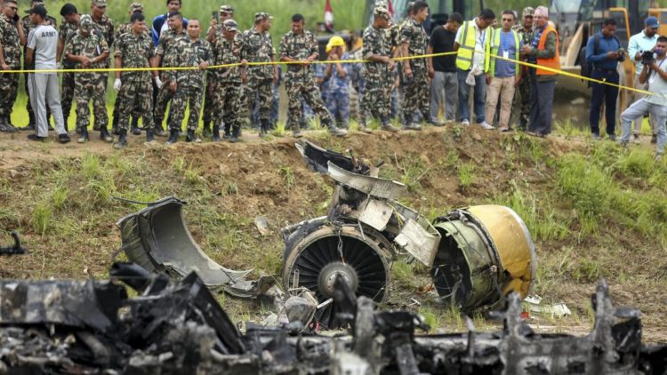 Nepal army personnel stand by a plane crash site at Tribhuvan International Airport in Kathmandu, Nepal, on July 24, 2024. State television in Nepal says a plane has slipped off the runway and crashed while trying to take off from the Kathmandu airport. | Photo Credit: AP