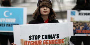 FILE PHOTO: People take part in a rally to encourage Canada and other countries as they consider labeling China's treatment of its Uighur population and Muslim minorities as genocide, outside the Canadian Embassy in Washington, D.C., U.S. February 19, 2021. REUTERS/Leah Millis/File Photo Purchase Licensing Rights