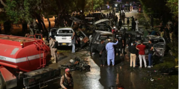 Security officials examine wreckage at the site of the explosion