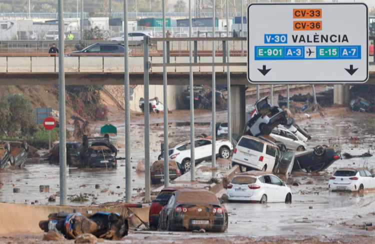 Damaged cars are seen along a road affected by torrential rains that caused flooding, on the outskirts of Valencia, Spain, October 31. REUTERS/Eva Manez Purchase Licensing Rights