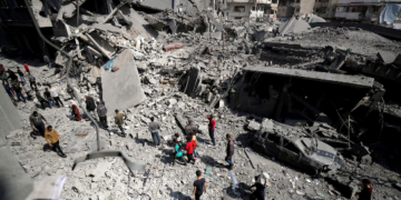 Palestinians inspect the site of an Israeli strike on a residential building in Jabalia, Gaza, on Tuesday. Mahmoud Issa/Reuters