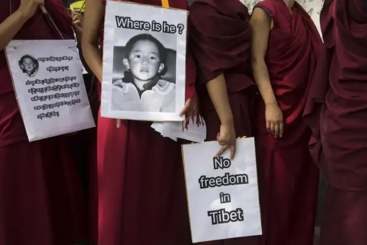 Exile Tibetan Buddhist nuns carry placards during a protest march demanding the release of their religious leader Gedhun Choekyi Nyima, the 11th Panchen Lama, who was put under house arrest by the Chinese authorities this day in 1995 in Tibet, in Dharmsala, India, Wednesday, May 17, 2017. © 2017 AP Photo/Ashwini Bhatia