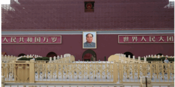 Security personnel keep watch near the portrait of late Chinese Chairman Mao Zedong displayed on the Tiananmen Gate, in Beijing on Tuesday. | REUTERS