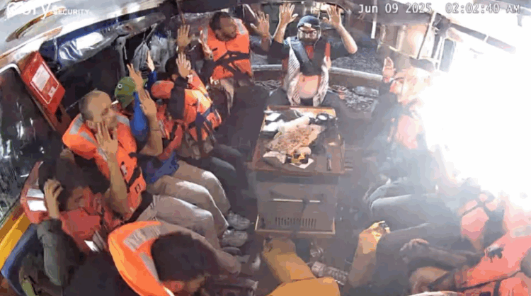 Crew members of the "Madleen" are seen with their hands in the air as Israeli forces come aboard, in this image from the Freedom Flotilla Coalition. Freedom Flotilla Coalition/Freedom Flotilla Coalition/Teleg 
