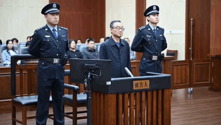 China's former agriculture minister Tang Renjian (centre) received a suspended death sentence for bribery at a court in Jilin province on Sunday, Sep 28, 2025. (Photo: Changchun Intermediate People's Court)