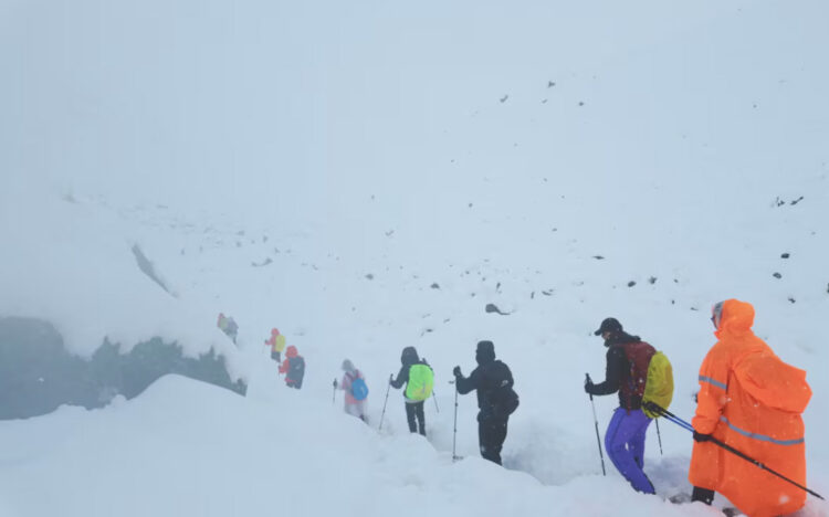 [1/4] A screen capture from video shows trekkers leaving their campsite, as unusually heavy snow and rainfall pummeled the Himalayas, in the Tibet Region, China, October 5, 2025. Geshuang Chen/Handout via REUTERS Purchase Licensing Rights