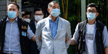 Police lead Hong Kong pro-democracy media mogul Jimmy Lai (C), 72, away from his home after he was arrested under the new national security law in Hong kong on August 10, 2020. Photo by by VERNON YUEN/AFP via Getty Images.