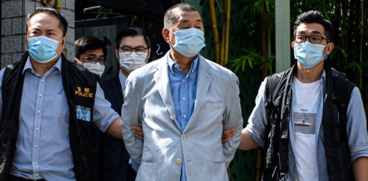 Police lead Hong Kong pro-democracy media mogul Jimmy Lai (C), 72, away from his home after he was arrested under the new national security law in Hong kong on August 10, 2020. Photo by by VERNON YUEN/AFP via Getty Images.