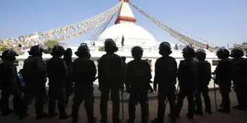 Nepalese police stand guard at the premises of the Boudhanath Stupa after a Tibetan monk self-immolated in Kathmandu on February 13, 2013. © 2013 Reuters