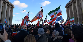 Protesters wave pre-1979 Islamic Revolution flags of Iran during a demonstration against the Iranian regime's crackdown on protests, in central Paris, on January 4, 2026. (Photo by Blanca CRUZ / AFP)